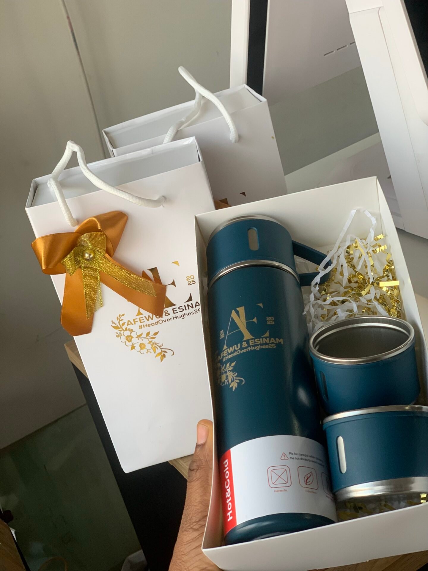 Flask with two lids in a gold foil printed paper box