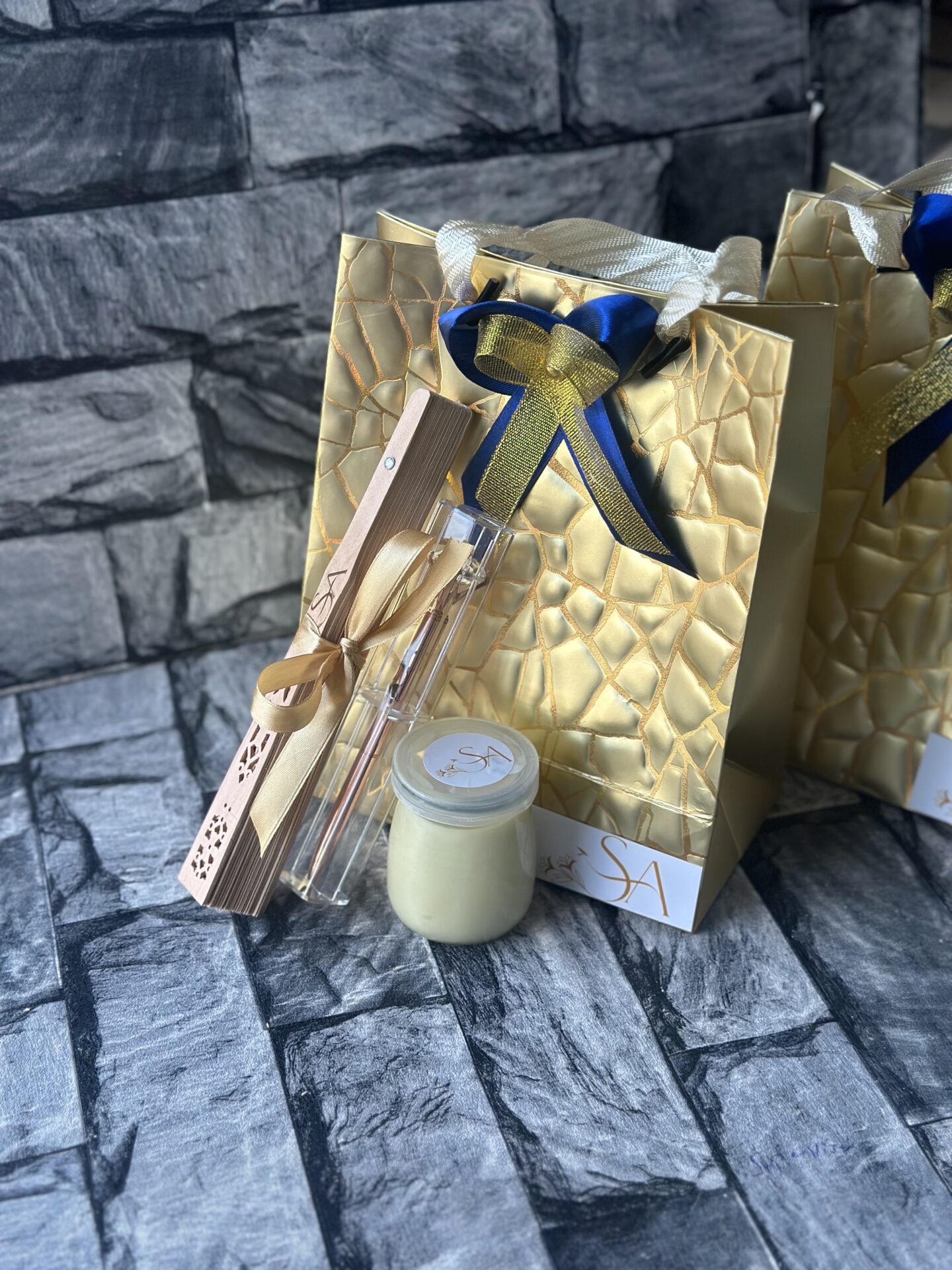 customized and packaged wooden fan and shea butter and cased pen